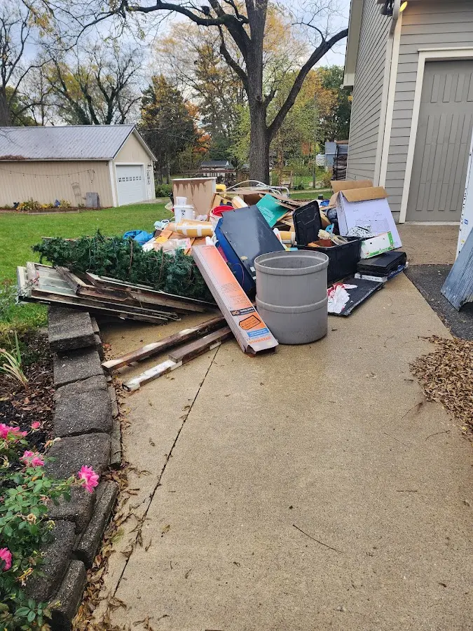 Dumpster being loaded with debris for Residential Dumpster Rental in St. Marys
